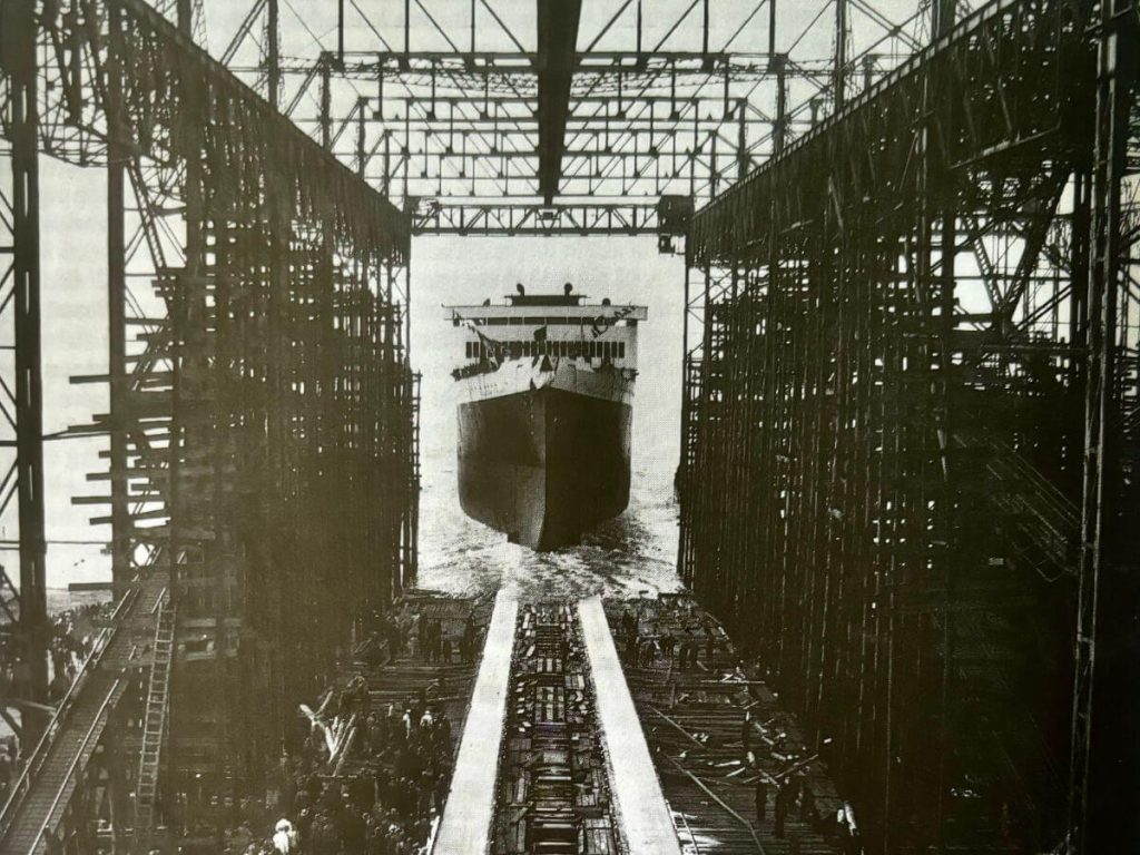 Launch of the S.S. President Coolidge down a ramp, off it's scaffold into the water