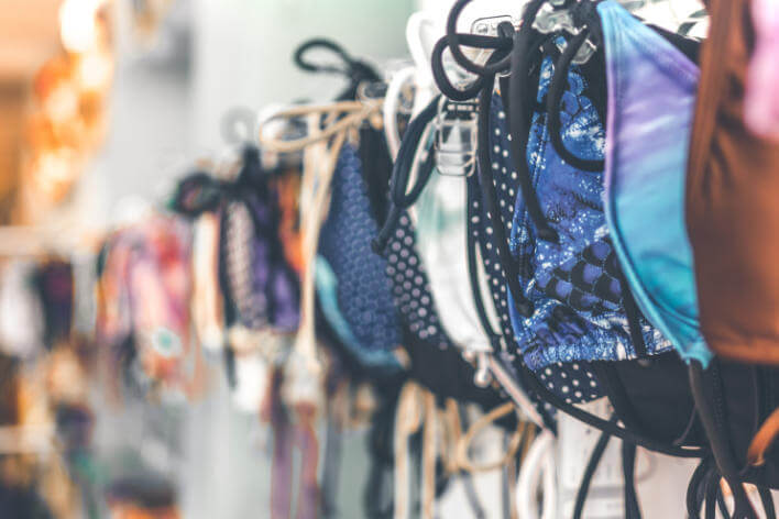 A Rack of different coloured bikinis on sale