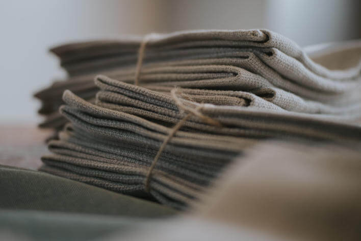A Stack of folded hemp squares tied with brown string