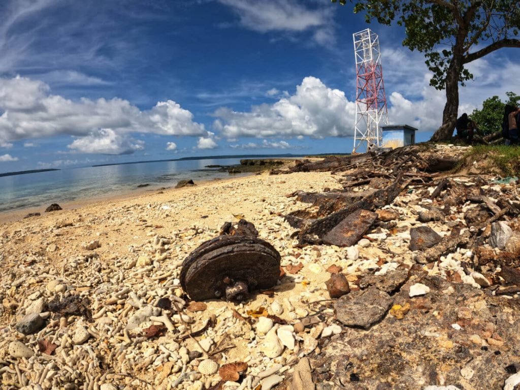 The beach in front of million dollar pint littered with rusted metal