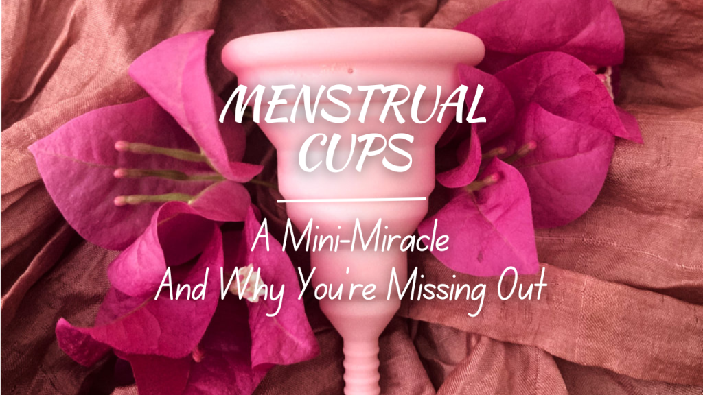 Pink Menstrual cup surrounded by pink bougainvillaea flowers on a pink scarf