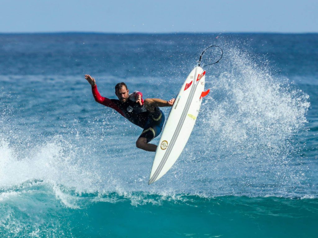 A Surfer riding a wave in the air