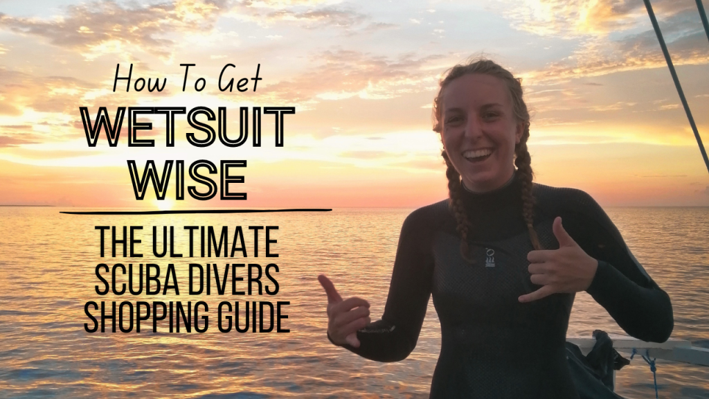 A woman smiling in a fourth element wetsuit, standing on a boat, infant of the sunset