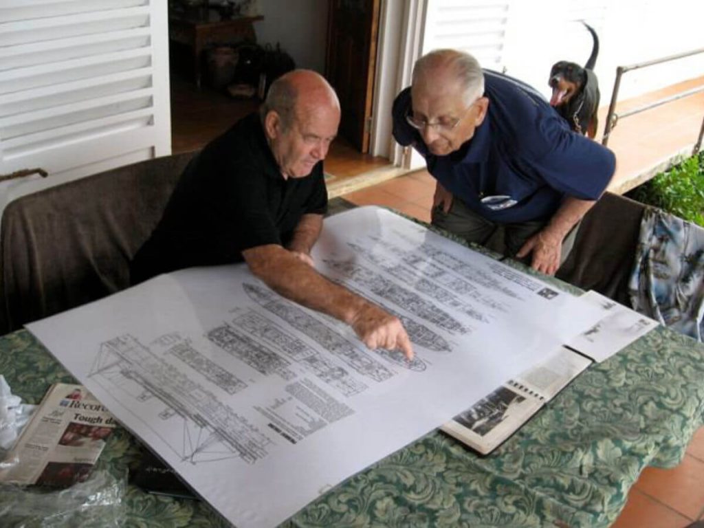 Allan Power pointing at a deck plan map of the SS President Coolidge to a diver