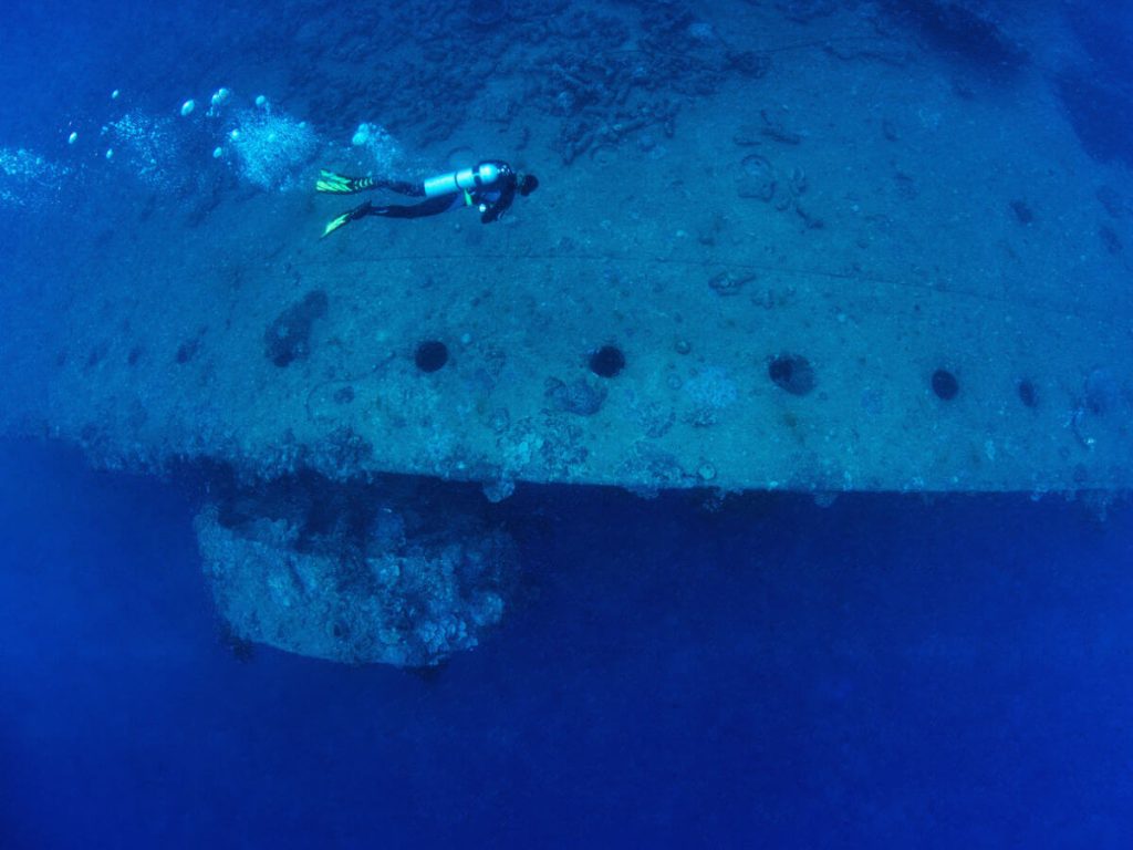 Diver showing scale of the SS President Coolidge dive site in Espiritu Santo, Vanuatu